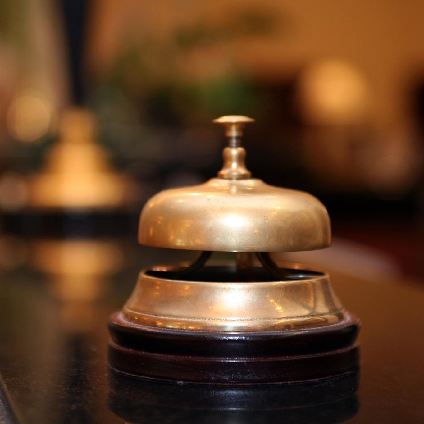 Brass service bell on a hotel front desk